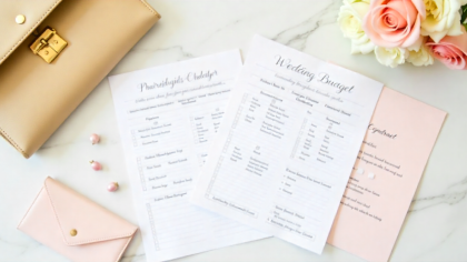 A beautifully styled flat lay showing a wedding budget planner, calculator, contracts, and elegant wedding stationery on a marble table, with soft beige and blush tones representing the financial planning side of Dubai weddings.